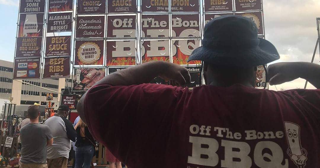 crew wearing off the bone BBQ t-shirt man making muscle